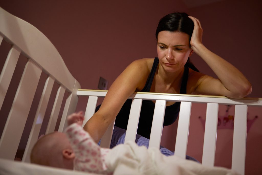 Baby crying with store legs out straight